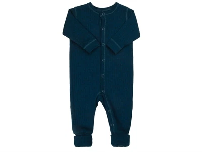 Joha uldheldragt i mørk turkis merinould med trykknapper og fødder  